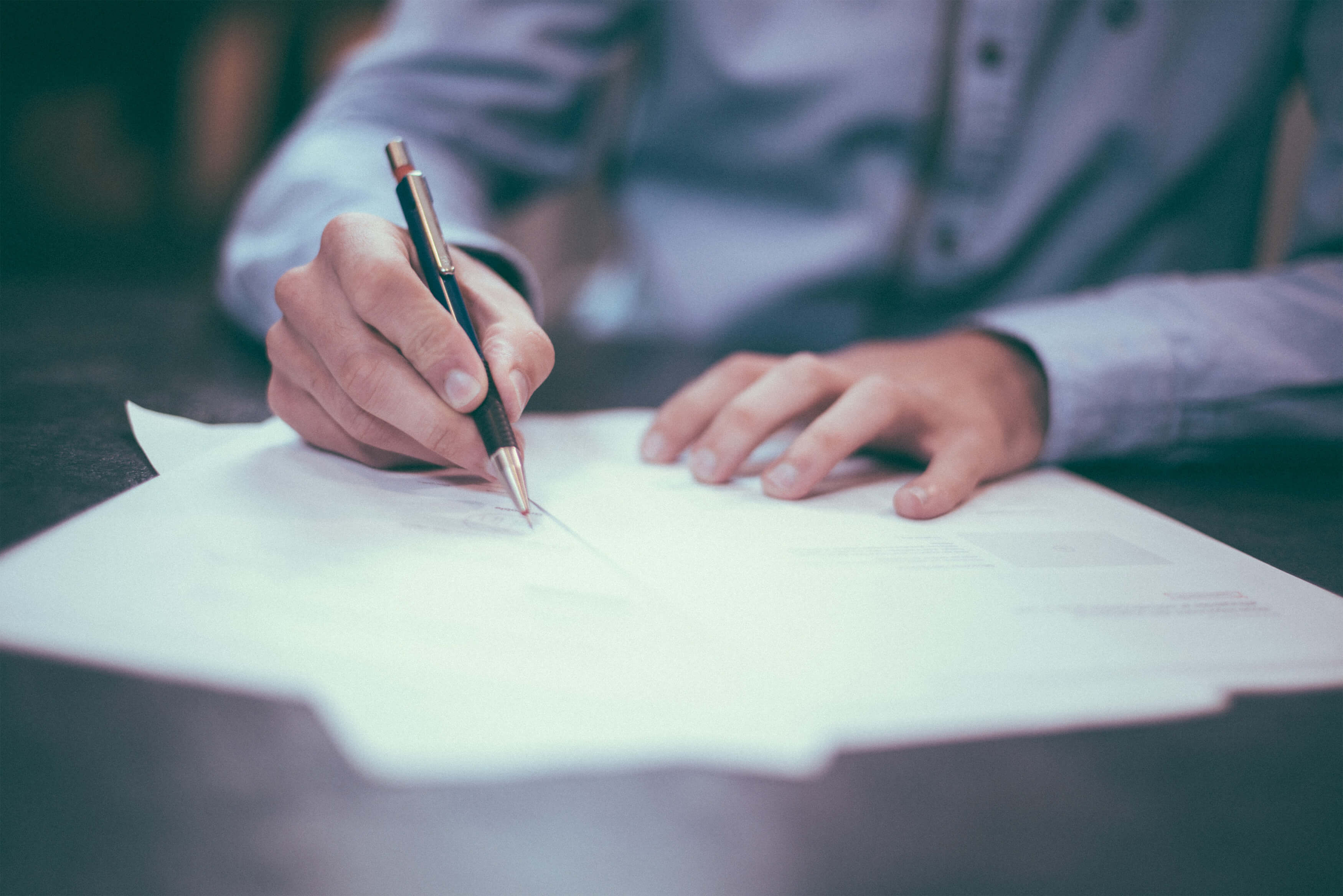 Writer planning website copy with a pen and paper